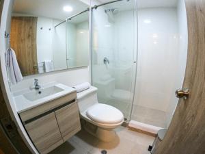 a bathroom with a shower and a toilet and a sink at Hotel 86 Suites in Bogotá +38 photos