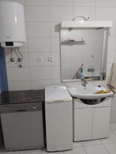 a white kitchen with a sink and a sink at Summer Garden View in Belgrade