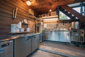 a large kitchen with stainless steel appliances in it at AJITO Chigasaki in Chigasaki