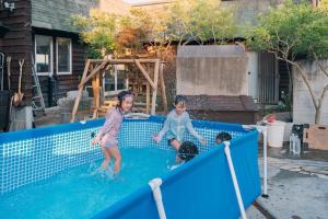 two children are playing in a swimming pool at AJITO Chigasaki in Chigasaki