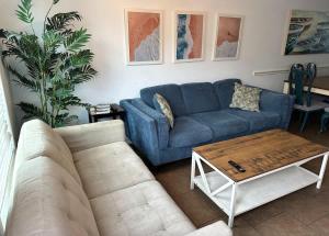 a living room with a blue couch and a coffee table at The Beach Peach in Port Aransas