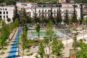 a park with trees and a tennis court at Apartment Simon - Berat City Center in Berat