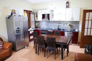 a kitchen with a table and a refrigerator at Apartment Simon - Berat City Center in Berat