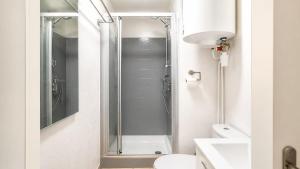 a bathroom with a shower and a toilet and a sink at Dramont Getaway in Saint-Raphaël
