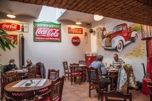 a group of people sitting at tables in a restaurant at Penzion Harley Pub in Otrokovice