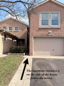 a house with an arrow pointing to a garage at Large Private Suit With Free Parking in Mississauga