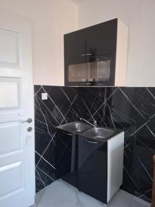 a bathroom with a sink and a microwave at Airport apartment Delić in Golubovci
