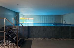 a large swimming pool with a staircase in a building at City Oasis in Santo Domingo
