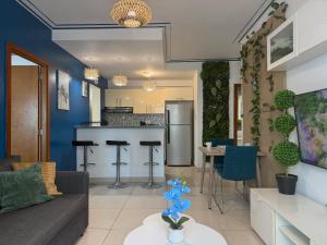 a living room with a couch and a kitchen at City Oasis in Santo Domingo