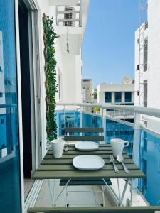 a balcony with a table with plates and utensils at City Oasis in Santo Domingo