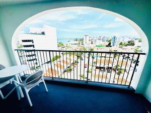 a balcony with a table and chairs and a view of a city at Relaxing Ocean View Condo by the Beach in San Juan