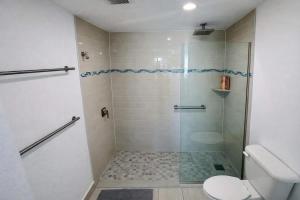 a bathroom with a shower and a toilet at Relaxing Ocean View Condo by the Beach in San Juan