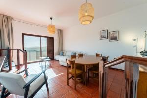 a living room with a table and a couch at Sailor House - By Wehost in Porto Santo