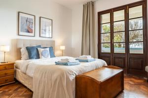 a bedroom with a bed with two towels on it at Sailor House - By Wehost in Porto Santo