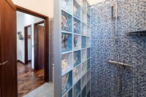a bathroom with blue tiled walls and a shower at Sailor House - By Wehost in Porto Santo +32 photos