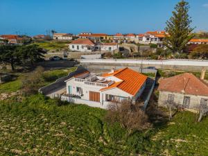 a white house with an orange roof in a village at Sailor House - By Wehost in Porto Santo