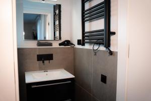 a bathroom with a sink and a mirror at Black Wood Tiny House in Mendig - Eifel Escape in Mendig +37 photos