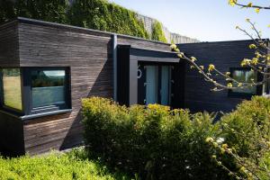 a black house with a black door and windows at Black Wood Tiny House in Mendig - Eifel Escape in Mendig