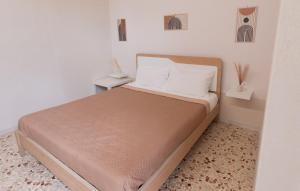 a bed in a small room with two tables at Civico Dodici in Modica