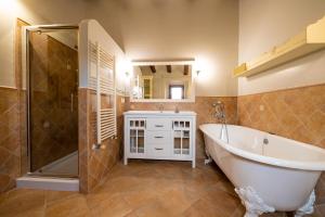 a bathroom with a tub and a shower and a sink at Ca L'Avi in Ca l’Avi +41 photos