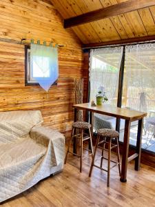 a dining room with a table and chairs in a cabin at House by the river in Ptuj +9 photos