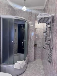a bathroom with a shower and a mirror at Liders17 in Odesa