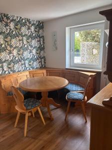 a dining room with a table and two chairs at Appartementhaus Silke in Bad Füssing
