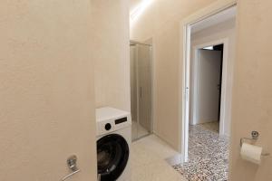 a laundry room with a washer and dryer at Civico Dodici in Modica