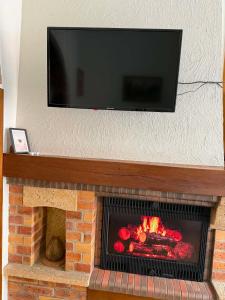 a fireplace with a tv on top of it at Studio Magnifique in Darnétal