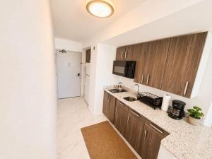 a kitchen with a sink and a counter top at Oceanview Beach Condo in Prime Location in San Juan