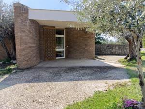 a brick house with a door and a tree at Home among the olive trees in Tivoli