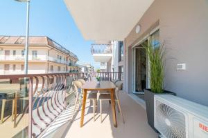 a balcony with a table and chairs on a building at Casa a due passi dal mare in Alba Adriatica