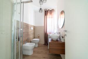 a bathroom with two toilets and a sink and a mirror at Casa a due passi dal mare in Alba Adriatica +15 photos