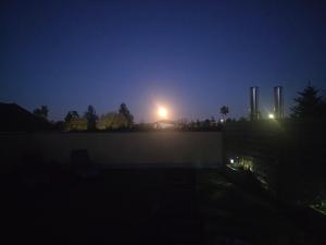 a nightime view of a building with a light behind it at Hawa's Penthouse Studio with Terrace in Eferding