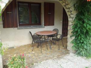 a table and chairs sitting on a patio at Apartment mit Gemeinschaftspool im Diois by Interhome in Die