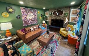a living room with a couch and a fireplace at Kitschy Kottage in Expansion
