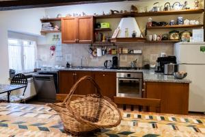 a kitchen with wooden cabinets and a basket on a table at C'era Una Volta B&B in Perugia