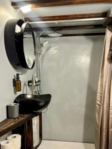 a bathroom with a black sink and a mirror at House by the river in Ptuj