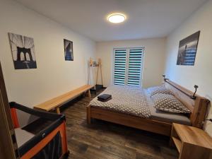 a bedroom with two beds and a window at Chalupa Jasanka in Červená Voda