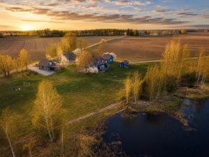 an aerial view of a house in a field next to a river at Gedvilų sodyba in Kelmė