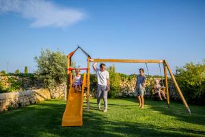 a group of people playing on a playground at Casal Sikelio in Cassibile