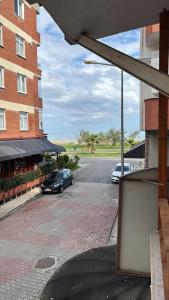 a parking lot with two cars parked in front of a building at Cağaloğlu Apart Butik Otel in Atakum