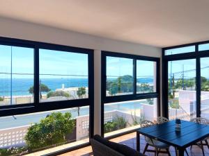 a living room with a view of the ocean at Chalet Playa Mazagon in Mazagón