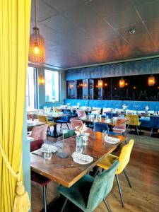 a dining room with wooden tables and chairs at ARGENTA Living 42 in Künzell
