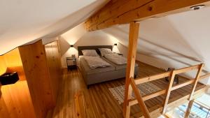 a bedroom with a bed and a loft at Ferienwohnung Am Bromberg in Schlehdorf