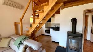 a living room with a fireplace and a stove at Ferienwohnung Am Bromberg in Schlehdorf