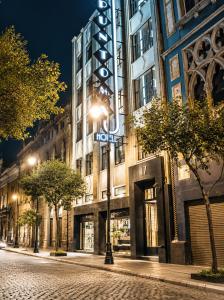 a building with a sign on the side of it at Hotel Punto MX in Mexico City