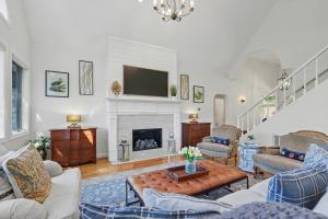 a living room with a fireplace and a tv at Chic Sky Valley Resort Home on Golf Course! in Sky Valley