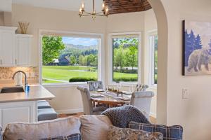 a kitchen and living room with a table and chairs at Chic Sky Valley Resort Home on Golf Course! in Sky Valley