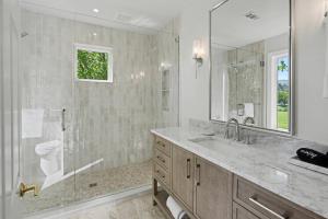 a bathroom with a sink and a toilet and a mirror at Chic Sky Valley Resort Home on Golf Course! in Sky Valley +24 photos